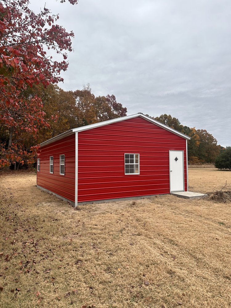 Red custom metal building with white trim on a rural property in Jonesville, NC