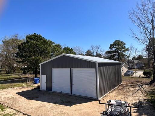 Prefab metal garage building with two roll-up doors installed in NC, representing metal buildings available in Charlotte NC
